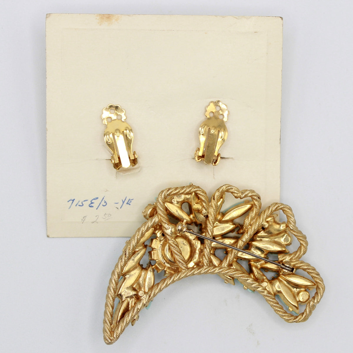 Reverse of vintage Juliana turquoise-color brooch and clip earrings on original card