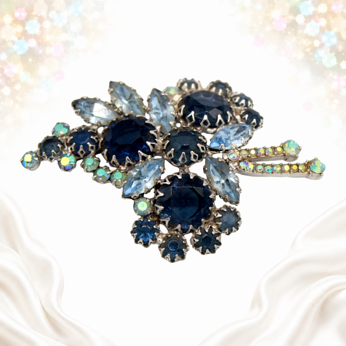 Vintage Juliana blue multi-prong rhinestone brooch, angled view