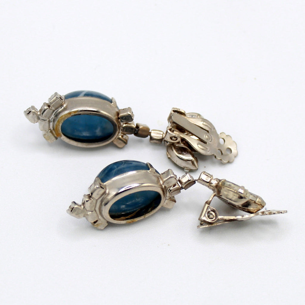 Backs of Juliana blue marbled Lucite clear rhinestone clip earrings with silver-tone clip hardware
