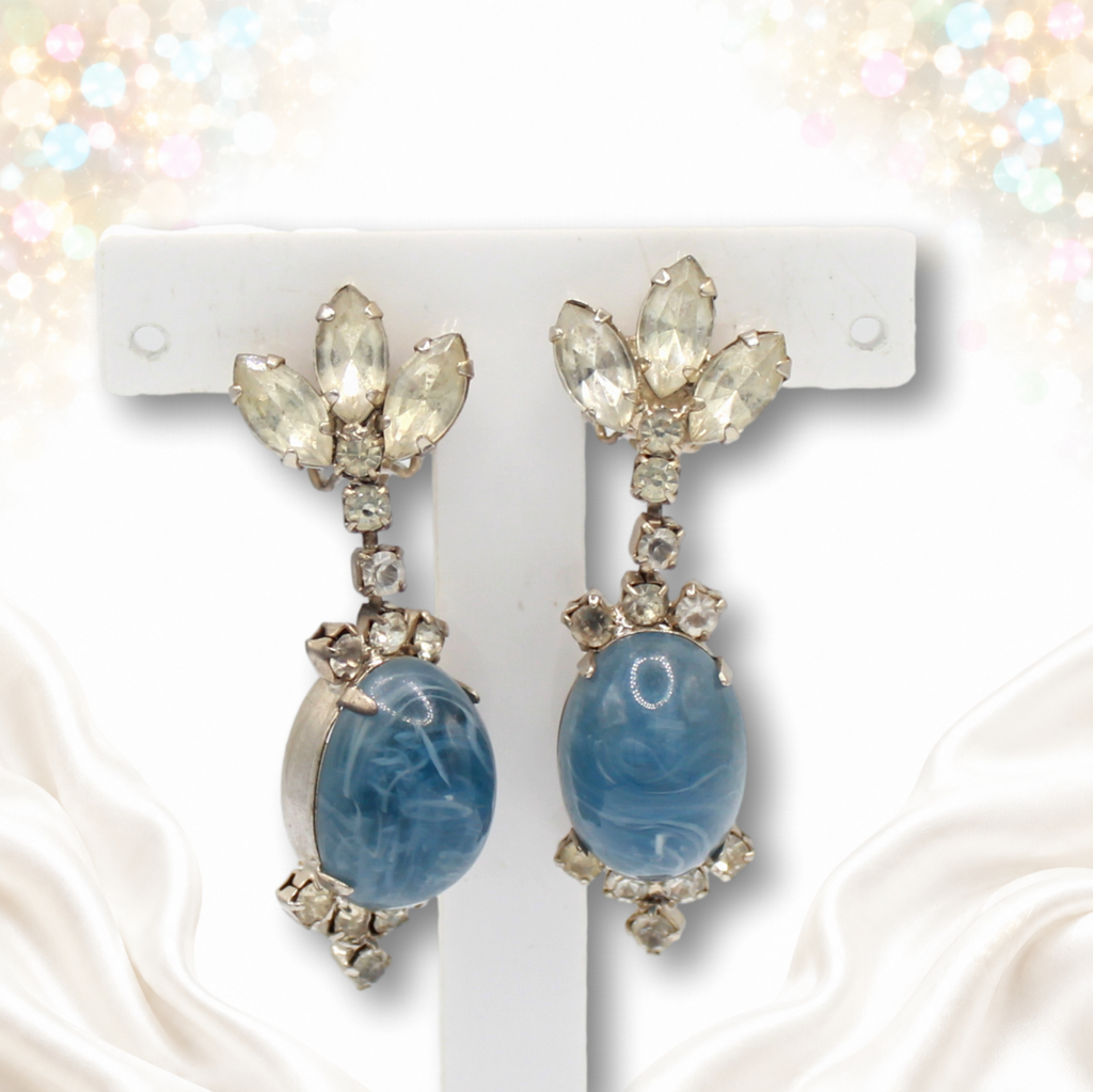 Juliana clear rhinestone and blue marbled cabochon clip-on earrings photographed on white display