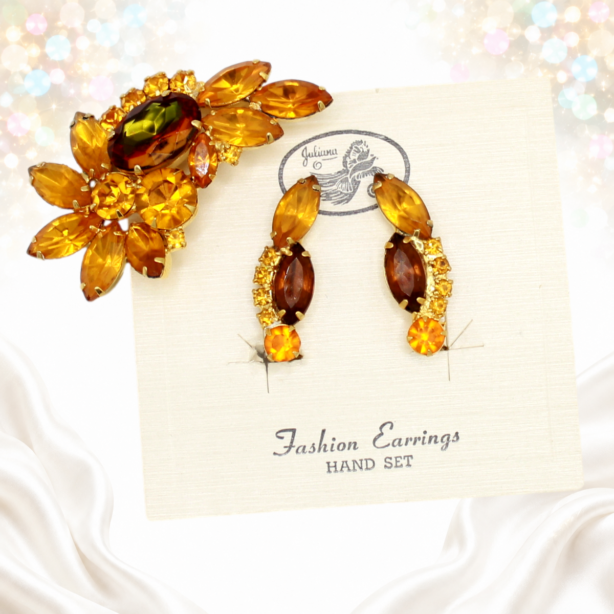 Angled view of Juliana topaz amber rhinestone brooch and original-card matching clip ear climber earrings