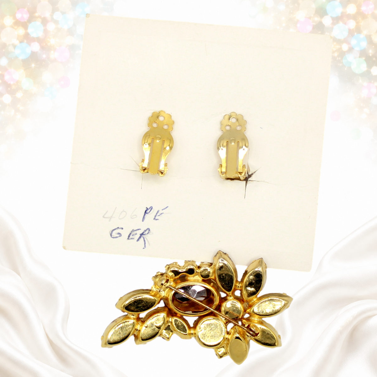 Reverse of Juliana gold-tone brooch and clip earrings on original Juliana display card