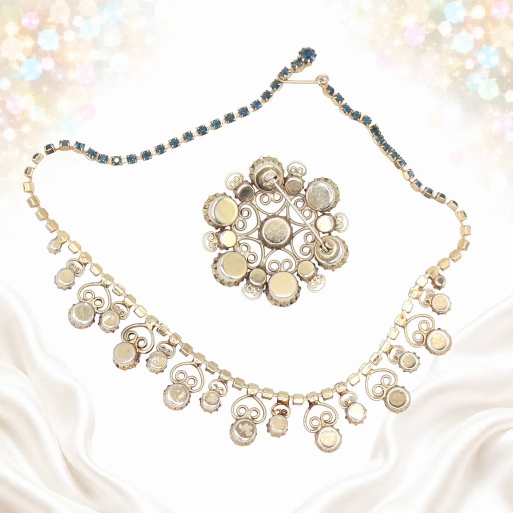 Reverse side of Juliana silver-tone necklace and round brooch showing settings and pin fastening
