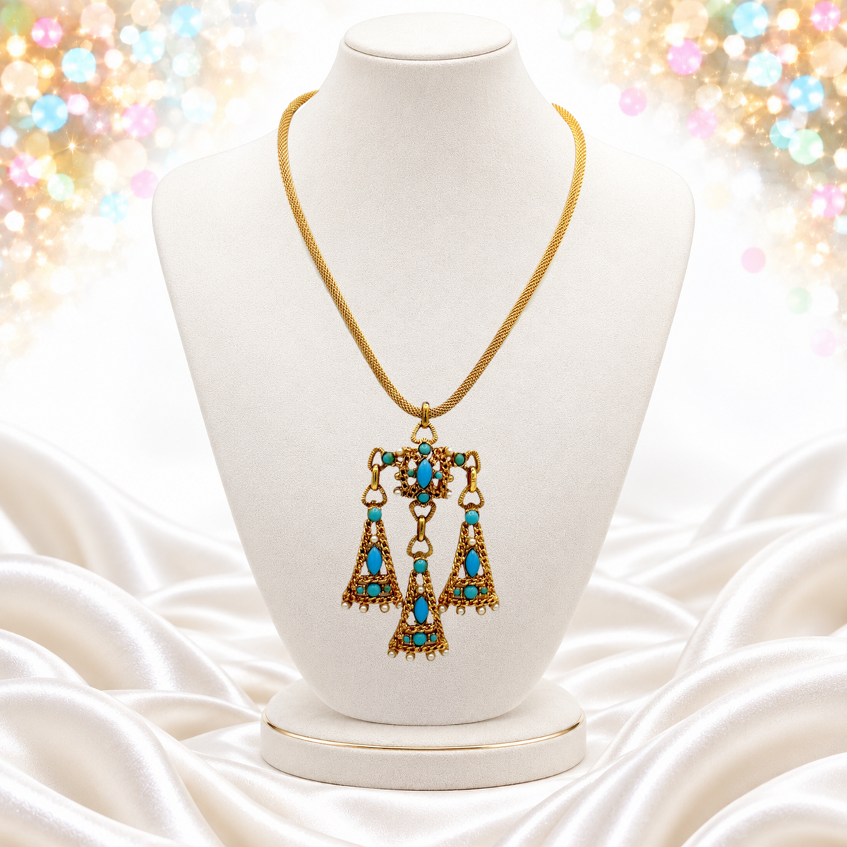 Vintage Juliana necklace on bust with bright turquoise-blue cabochons and three articulated gold-tone drops