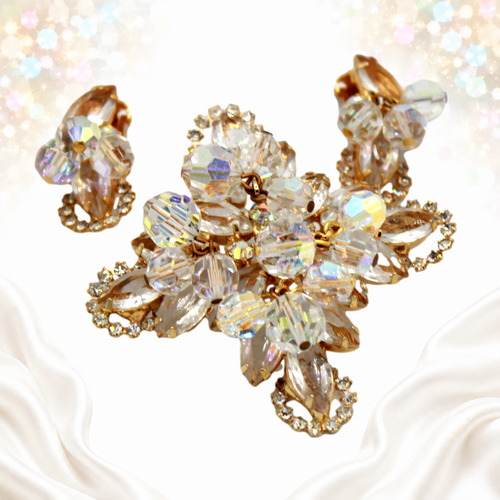 Angled view of clear rhinestone and AB crystal bead halo brooch and earrings set