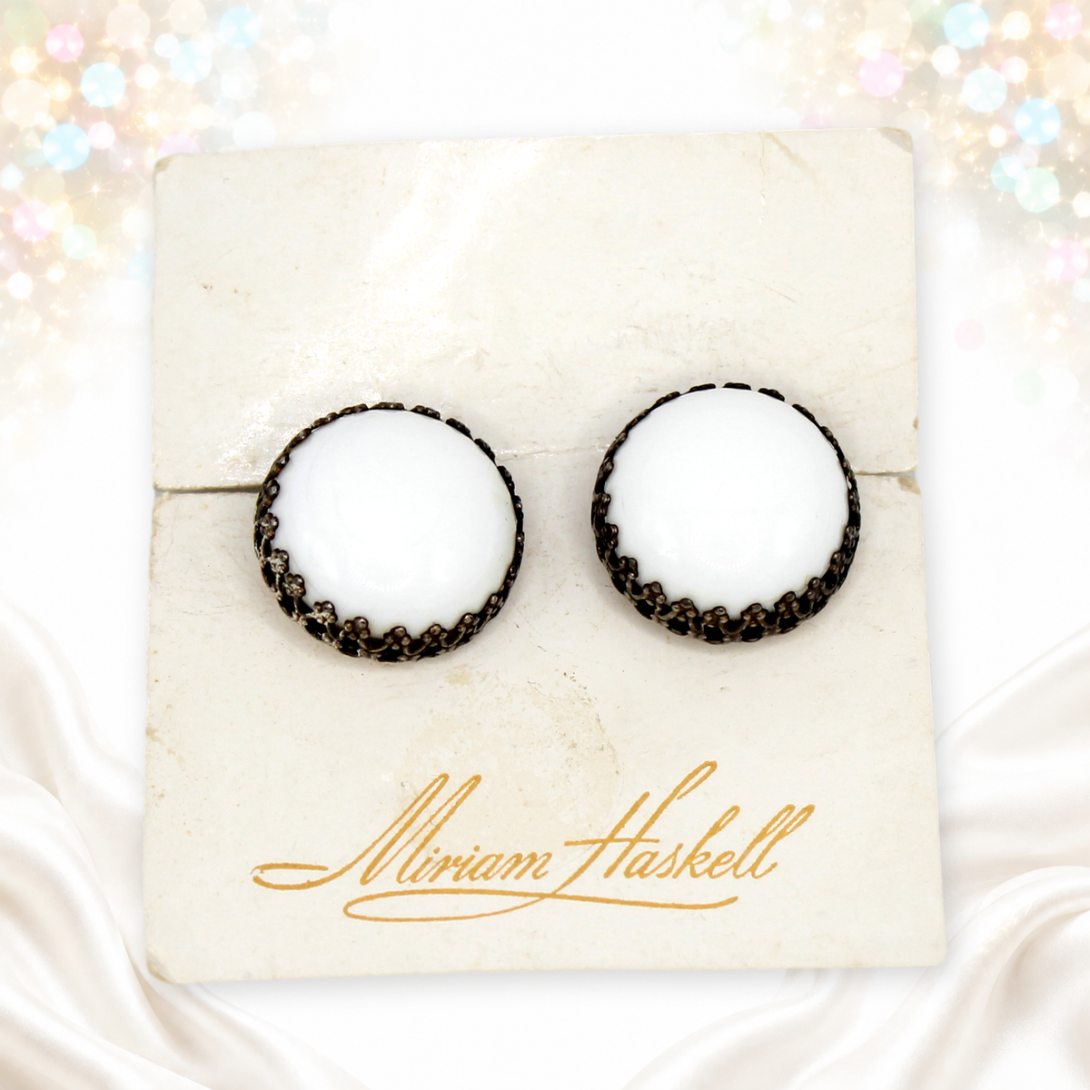 Vintage Miriam Haskell white cabochon clip earrings on original card front