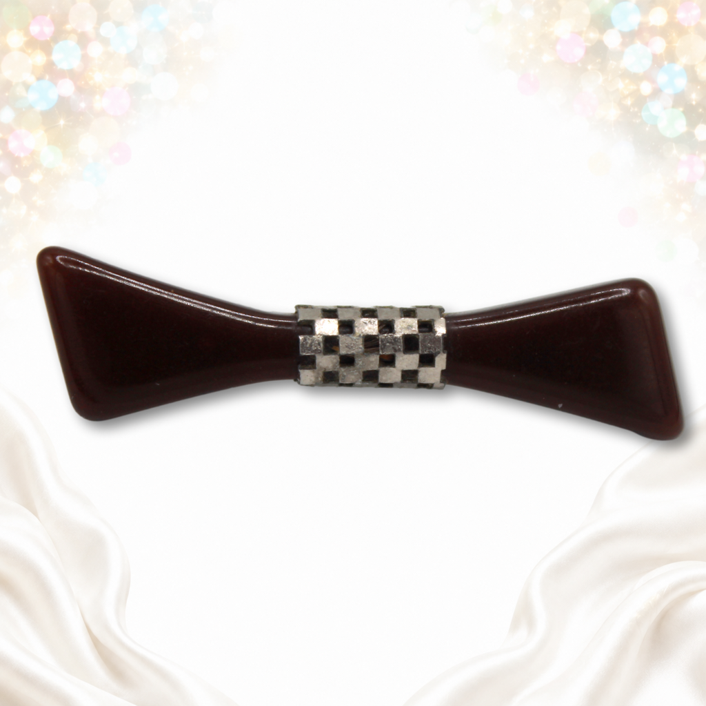 Brown Bakelite bow brooch with silver-tone openwork checkerboard band, front photograph on signature background