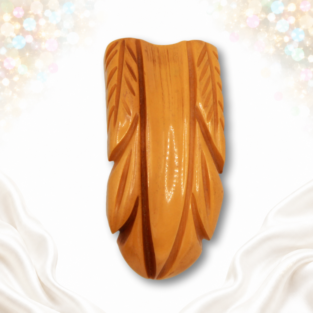 Vintage deeply carved butterscotch Bakelite dress clip front view
