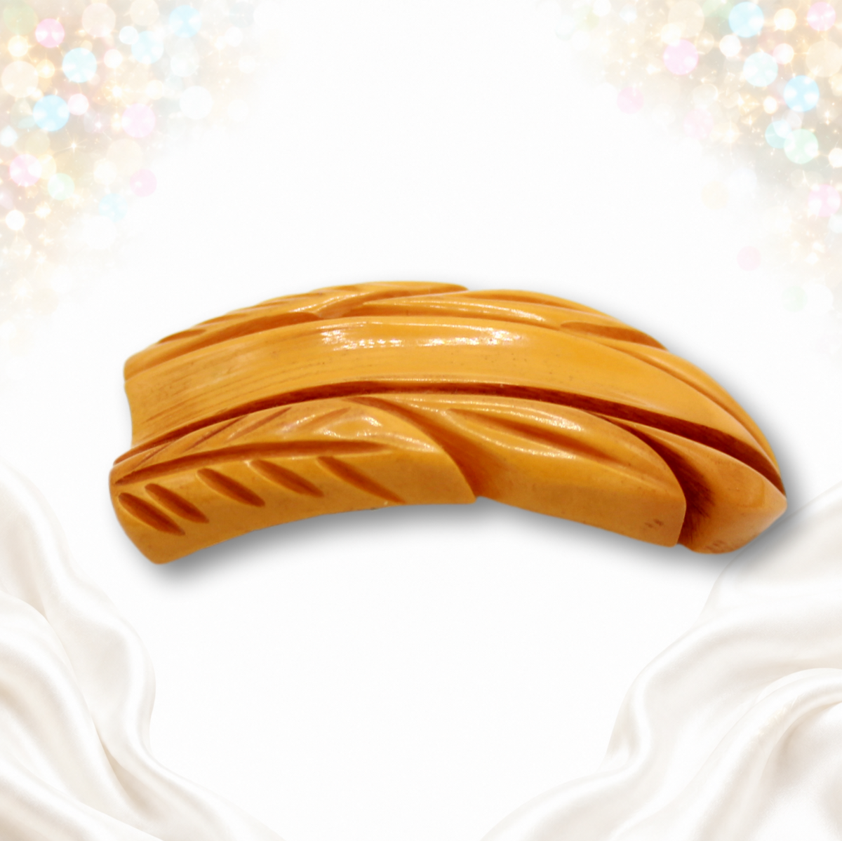 Vintage butterscotch Bakelite dress clip alternate angled view showing carved depth
