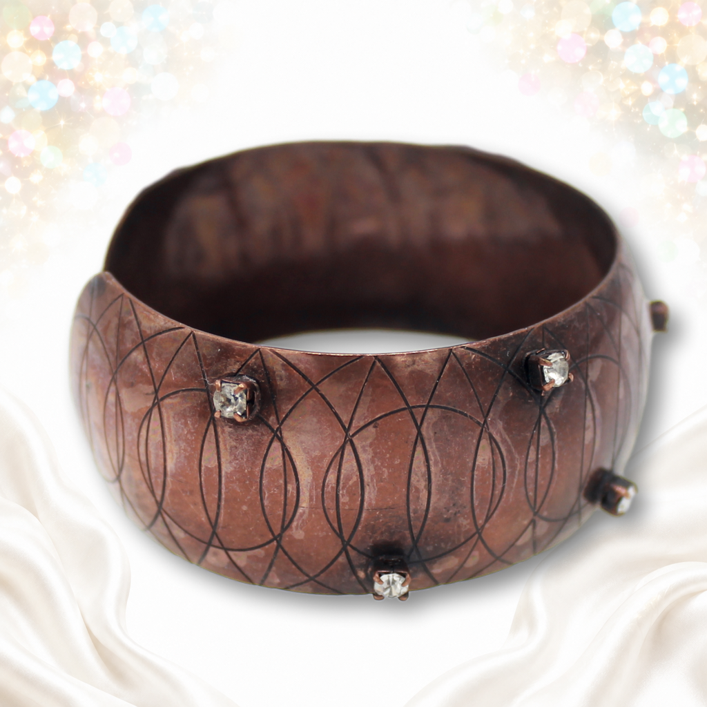 Angled front view of Juliana copper-tone circle-engraved cuff