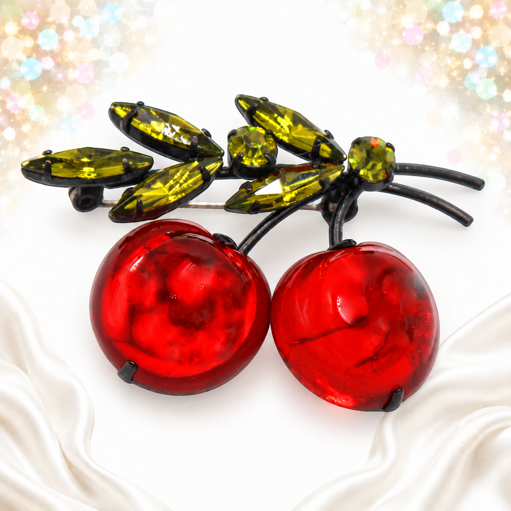 Angled view of Austria red plastic apple brooch
