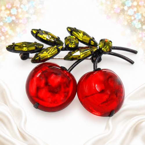 Angled view of Austria red plastic apple brooch