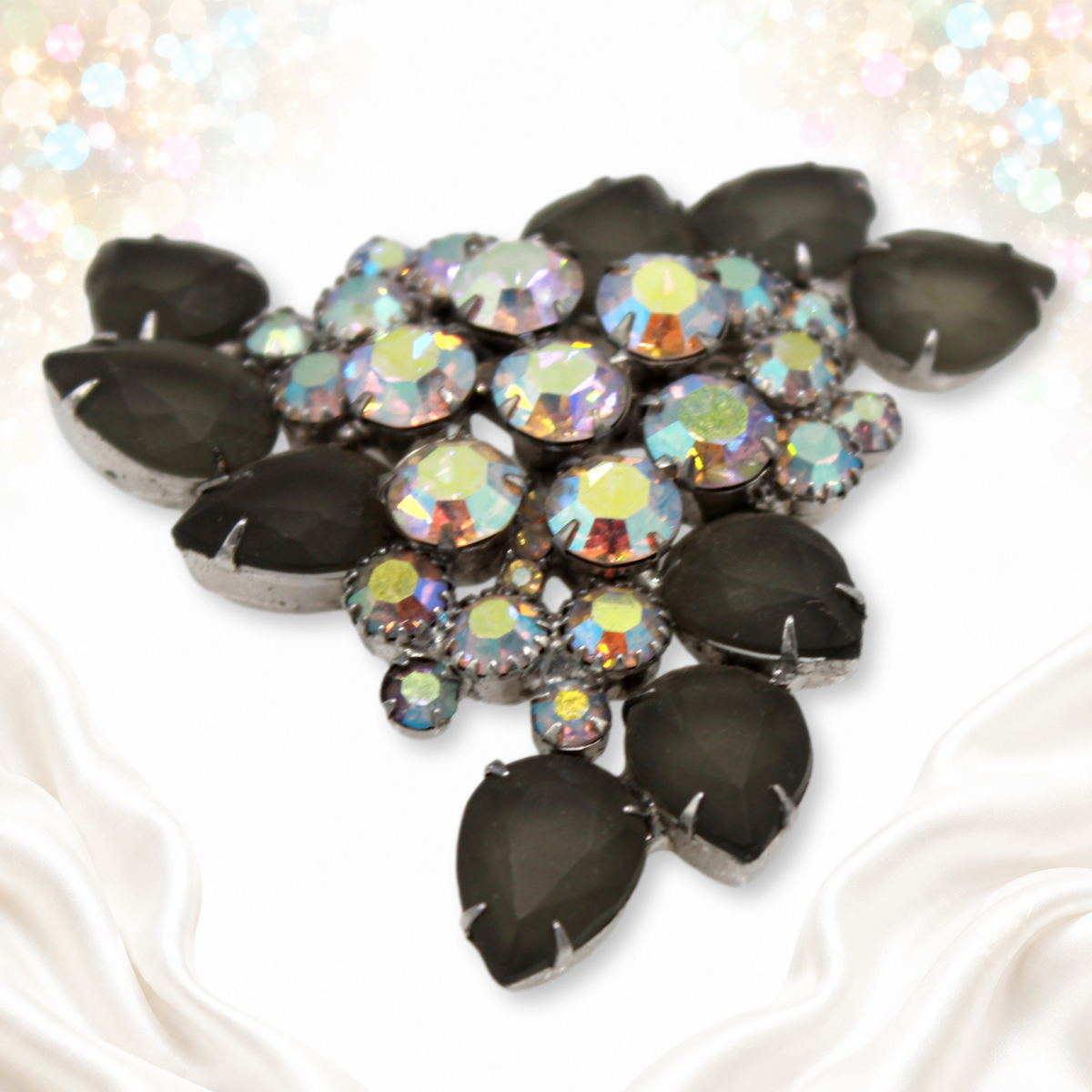 Angled side view of Juliana brooch with layered aurora borealis rhinestones and gray pears