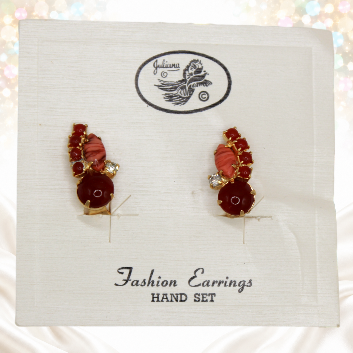 Juliana faux carnelian and faux coral rhinestone clip earrings on original Juliana card