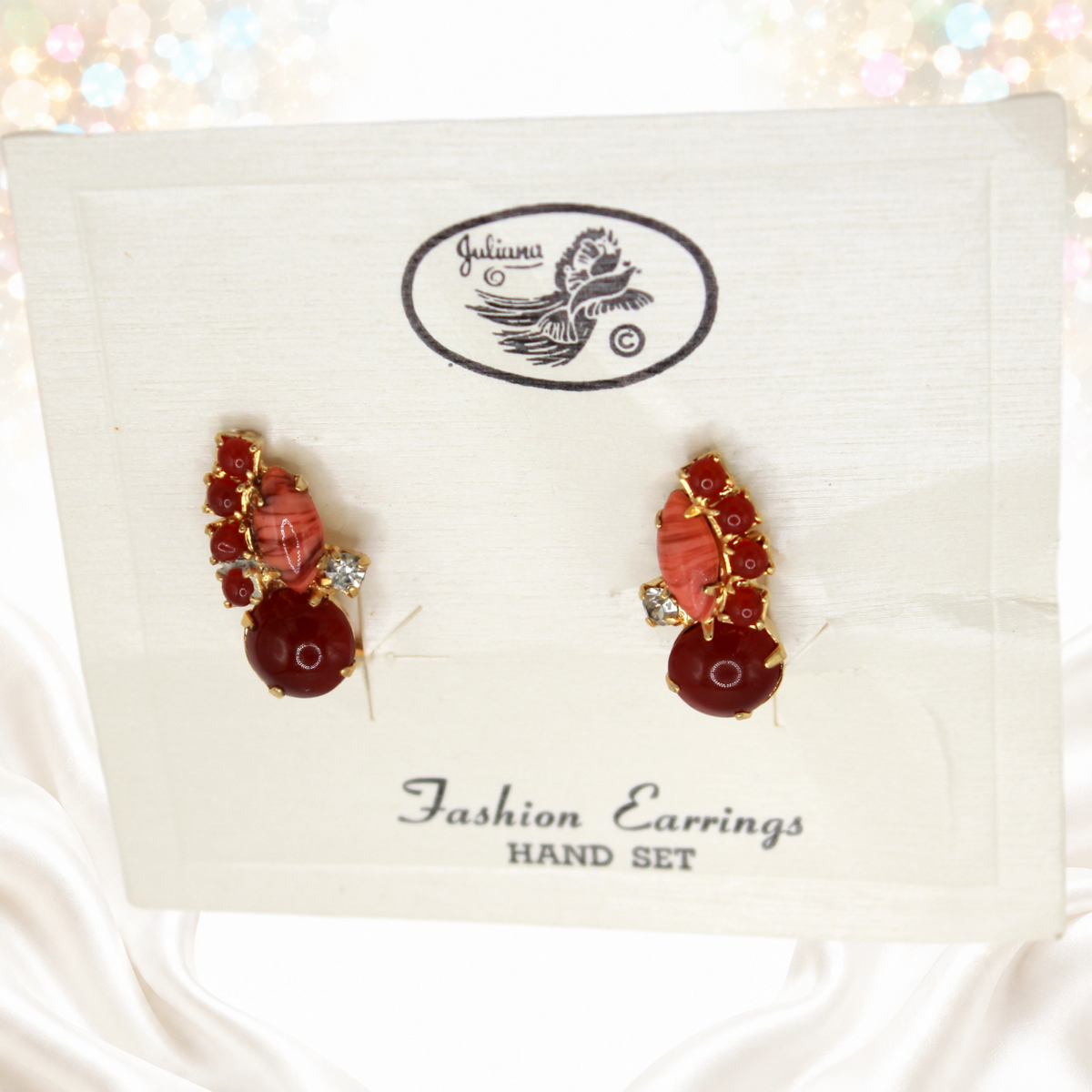 Detail of striped faux coral cabochons and reddish-brown faux carnelian stones