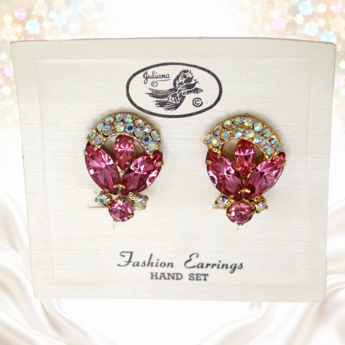 Juliana pink and AB rhinestone ribbon-family clip earrings on original Juliana card