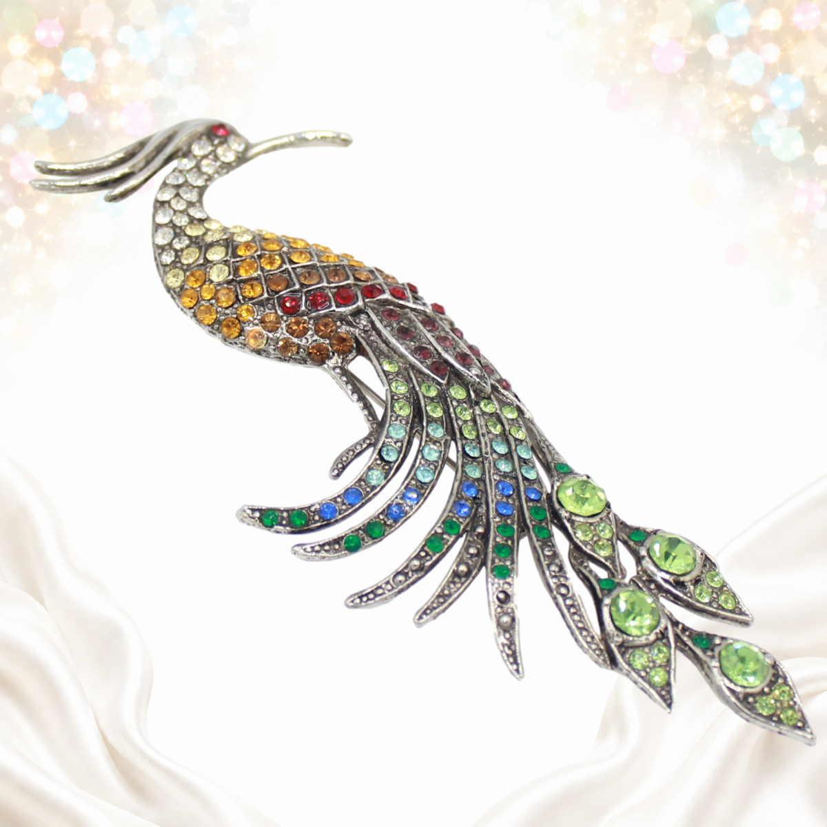 Angled view showing the sweeping rhinestone tail and silver-tone peacock casting
