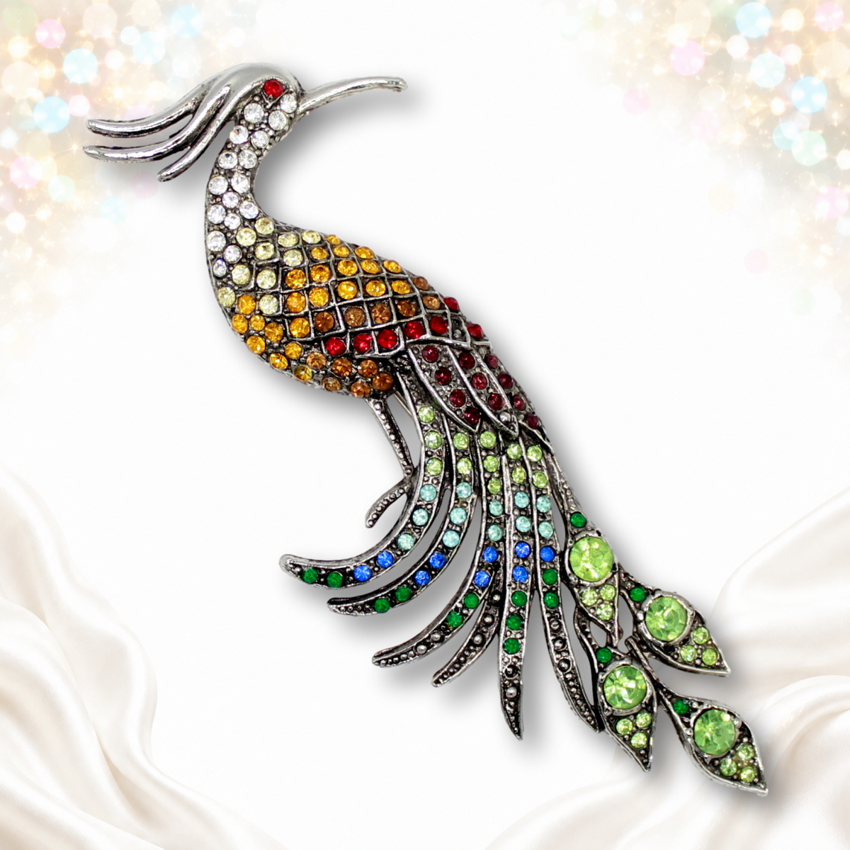 Long silver-tone peacock brooch with multicolor rhinestones, red eye and green tail accents