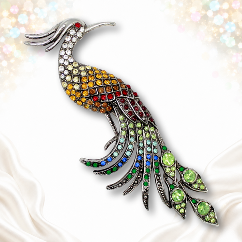 Long silver-tone peacock brooch with multicolor rhinestones, red eye and green tail accents