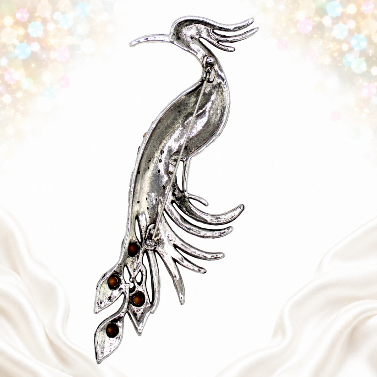 Unsigned reverse of long silver-tone peacock brooch with pin fastening