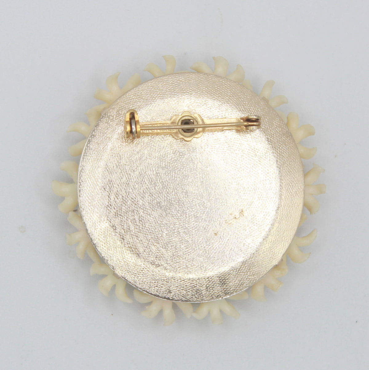 Back of vintage plastic daisy cluster brooch