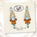 Vintage Juliana blue and topaz rhinestone dangling clip earrings on original Juliana display card