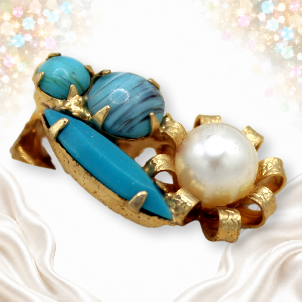 Close view of earring with faux turquoise and faux pearl