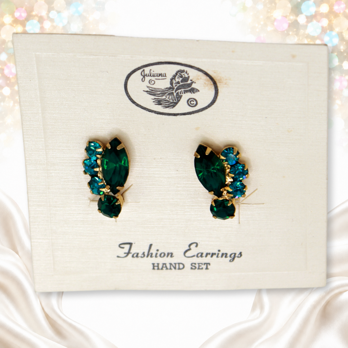 Angled view of green navettes and teal chatons on original Juliana card