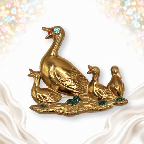 Gold-tone mother duck and three ducklings brooch with enamel accents and blue rhinestone eye