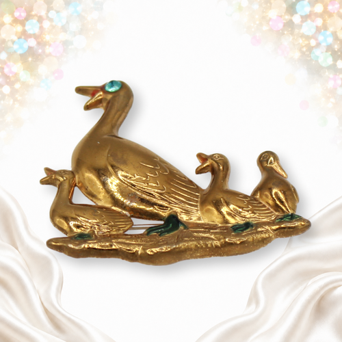 Gold-tone mother duck and three ducklings brooch with enamel accents and blue rhinestone eye